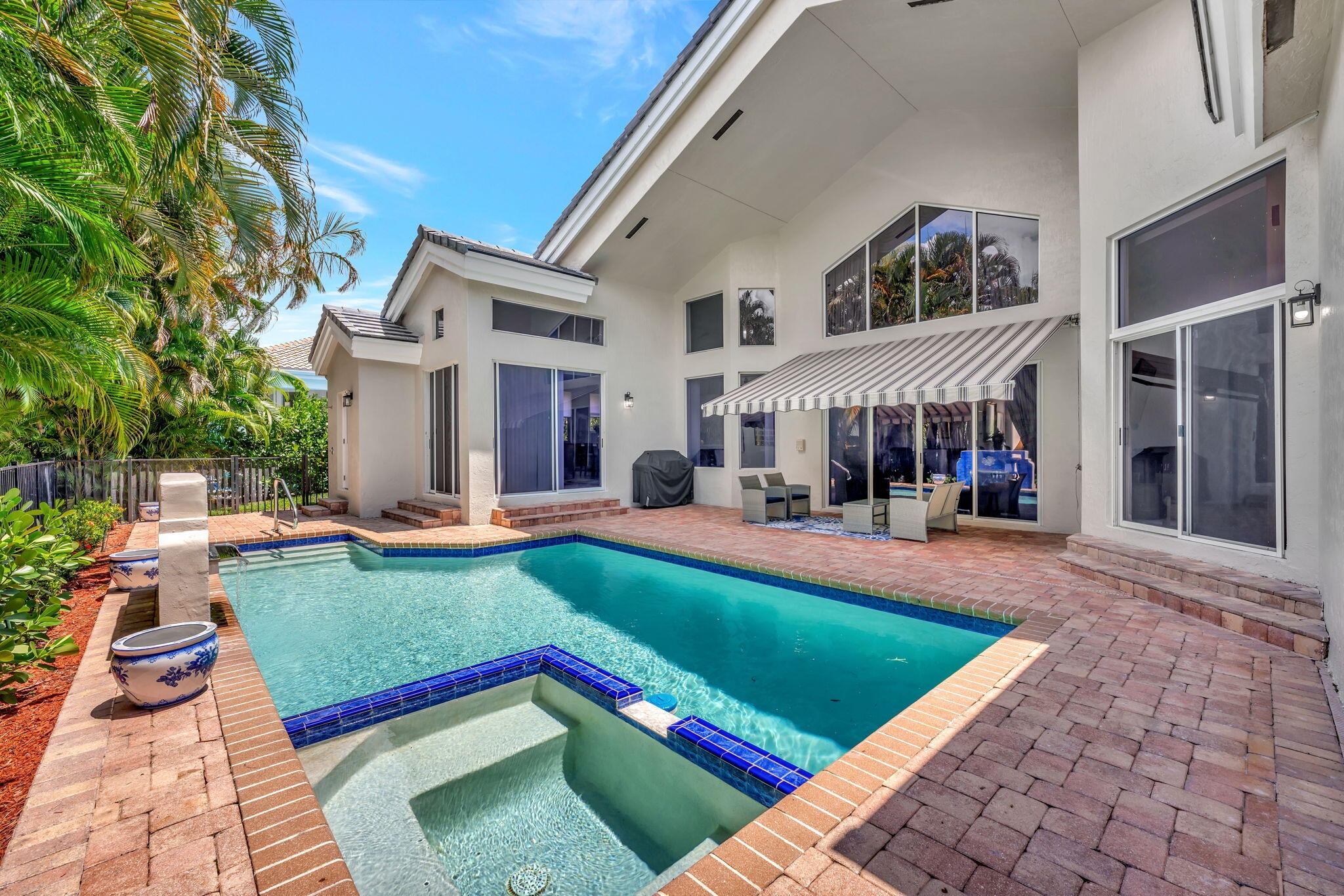 6039 Northwest 31st Terrace Boca Raton, FL 33496 - Photo 60 of 70 a view of a house with swimming pool and sitting area