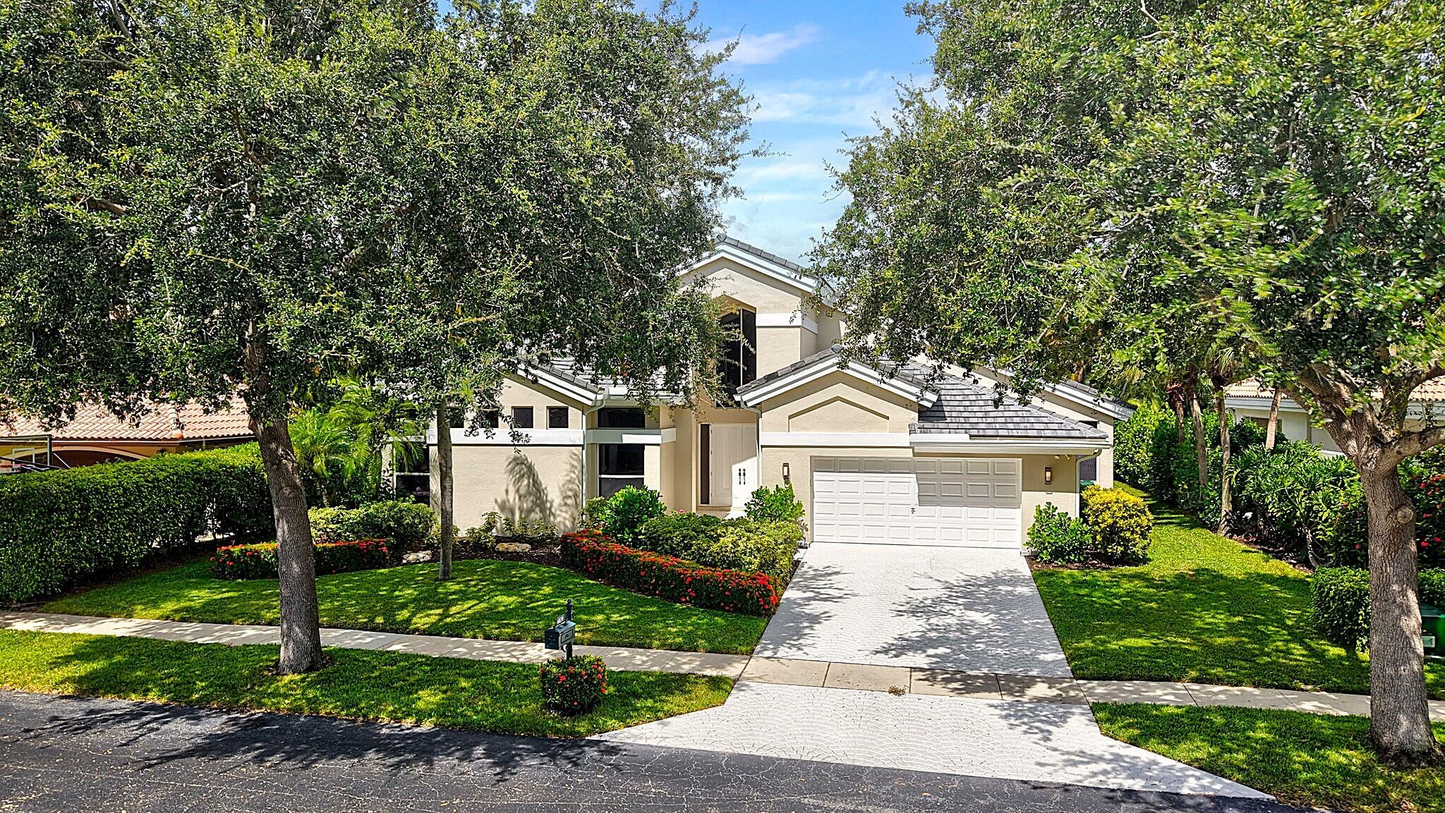 6039 Northwest 31st Terrace Boca Raton, FL 33496 - Photo 64 of 70 a front view of a house with a garden