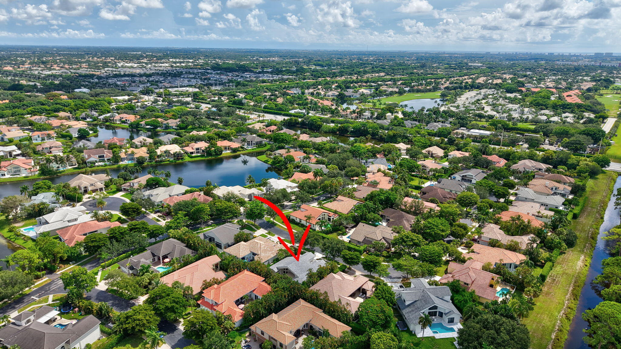 6039 Northwest 31st Terrace Boca Raton, FL 33496 - Photo 66 of 70 an aerial view of residential houses with outdoor space and trees