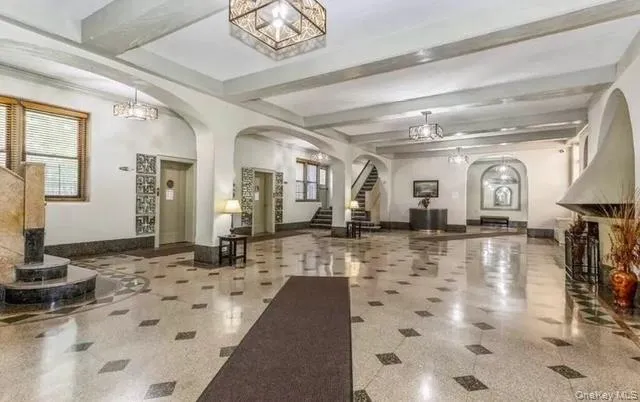 a lobby with a couch and a chandelier