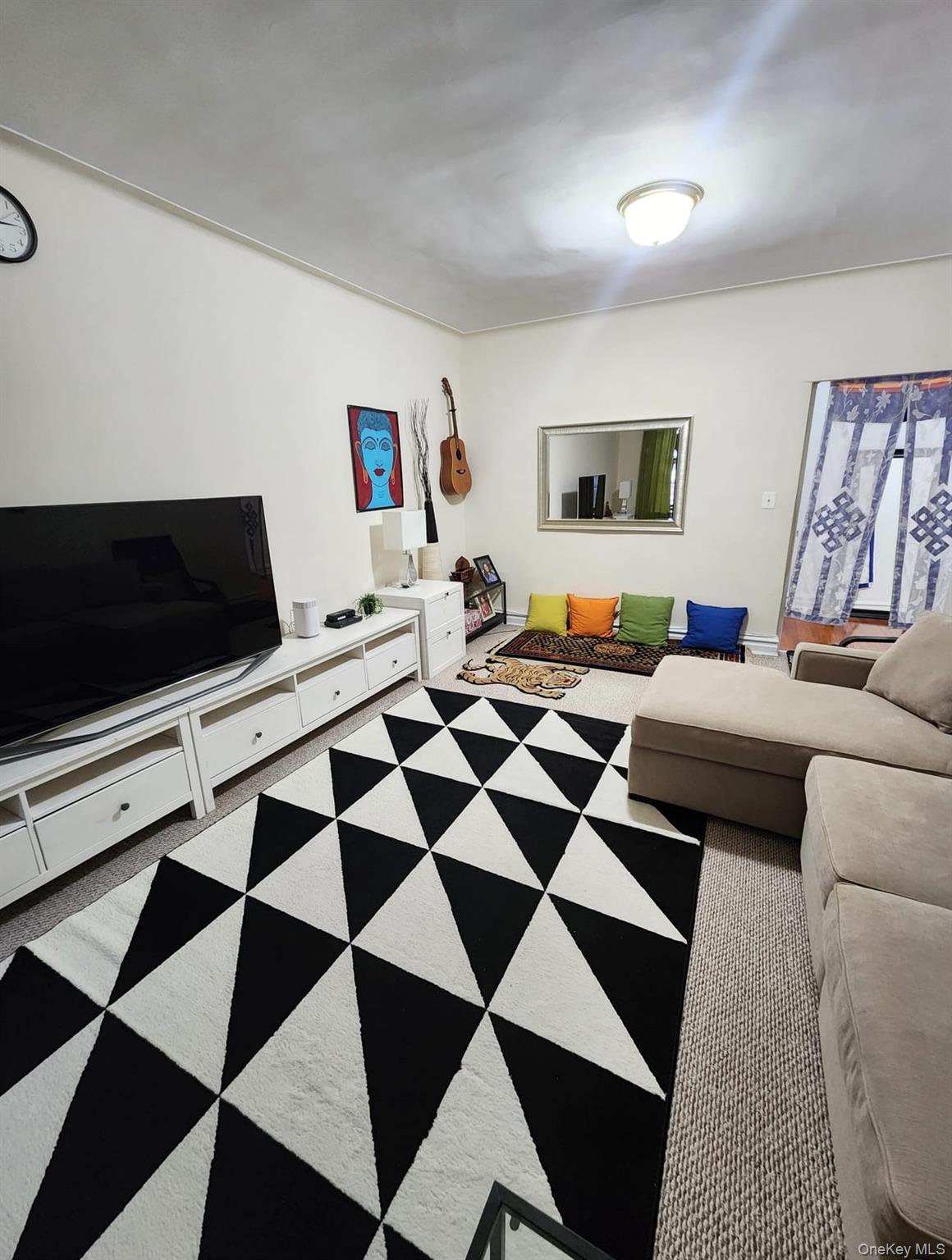 35-21 81st Street, Unit 2A Queens, NY 11372 - Photo 6 of 10 a living room with a black white checkered floor with black white checkered floor