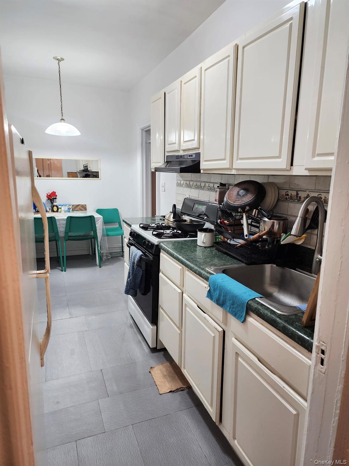 35-21 81st Street, Unit 2A Queens, NY 11372 - Photo 7 of 10 a kitchen with stainless steel appliances granite countertop a sink stove and cabinets