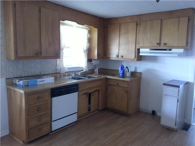 2792 Grays Bend Road Centerville, TN 37033 - Photo 11 of 14 a kitchen with sink cabinets and window