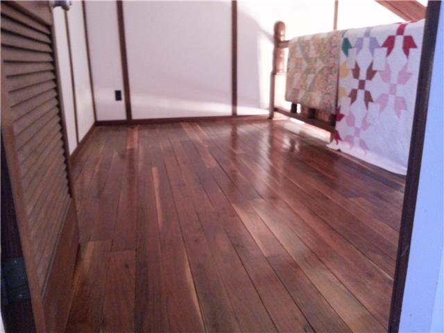 2792 Grays Bend Road Centerville, TN 37033 - Photo 9 of 14 a view of a room with wooden floor and a ceiling fan
