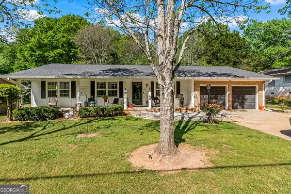 a front view of a house with a yard table and chairs
