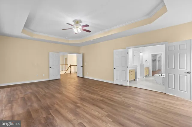 a bathroom with a toilet a sink a mirror a bathtub and vanity