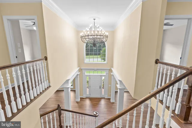 a large kitchen with stainless steel appliances wooden floors large counter space and wooden floor