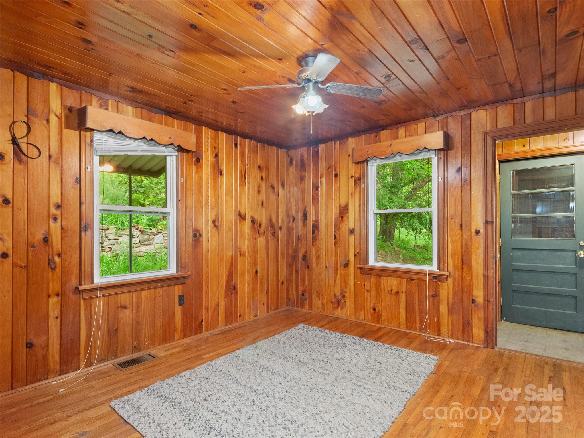 49 Caring Pl Loop Clyde, NC 28721 - Photo 12 of 18 an empty room with a ceiling fan and windows