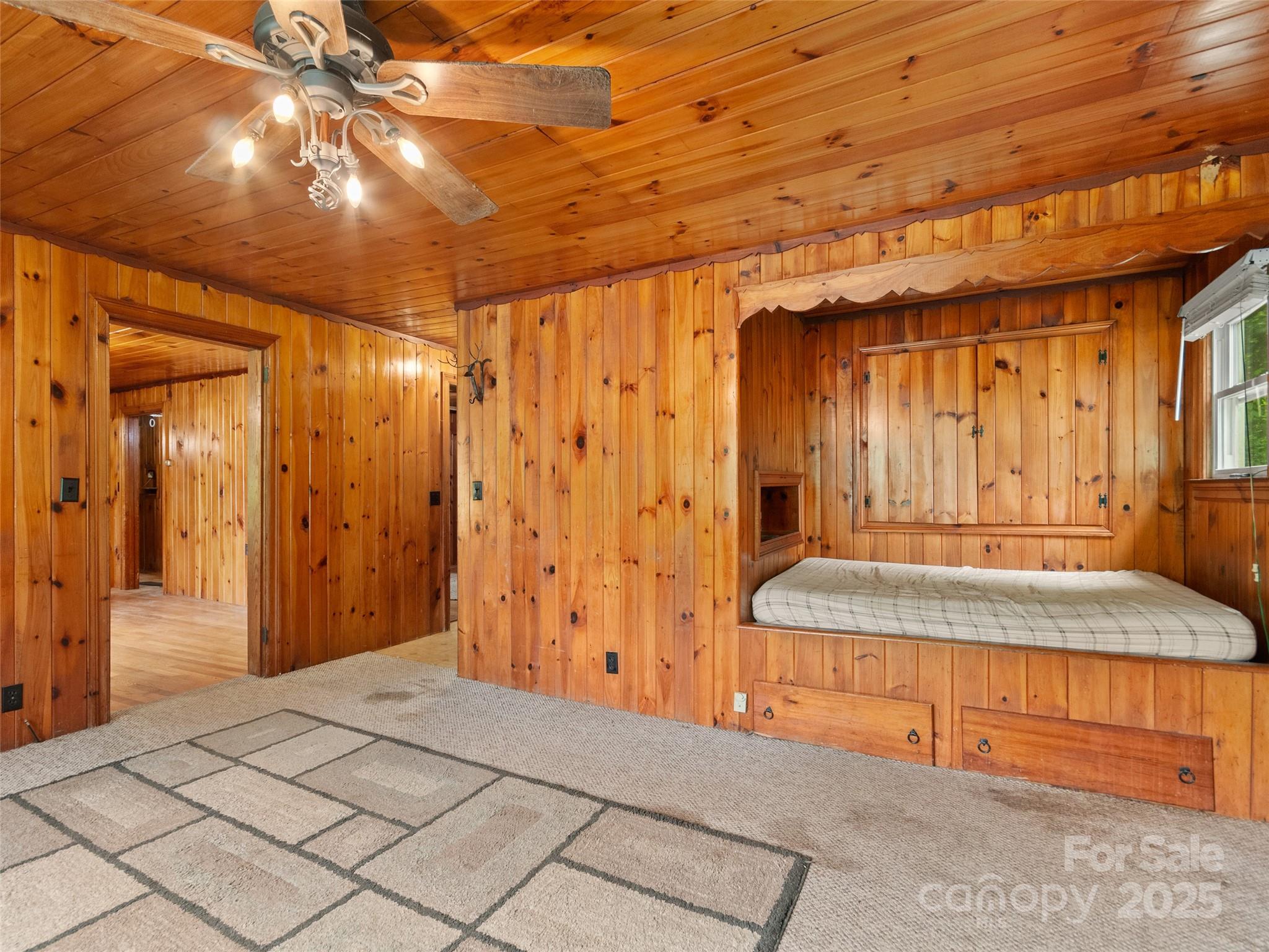 49 Caring Pl Loop Clyde, NC 28721 - Photo 13 of 18 a spacious bedroom with a large bed and a chandelier