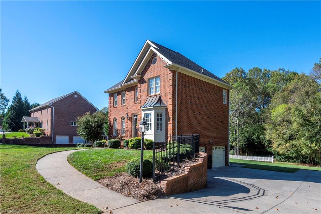 8930 Doubletree Lane Clemmons, NC 27012 - Photo 4 of 49 Concrete driveway to roomy 2-car garage, with individual garage doors.