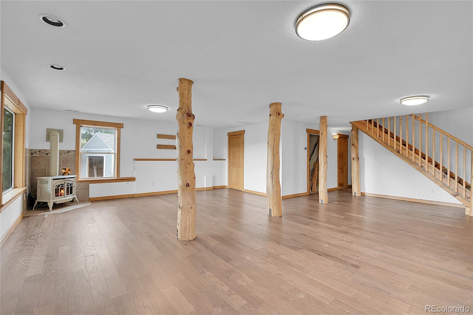 211 Chalet Drive Black Hawk, CO 80422 - Photo 19 of 36 a view of empty room with wooden floor and fan