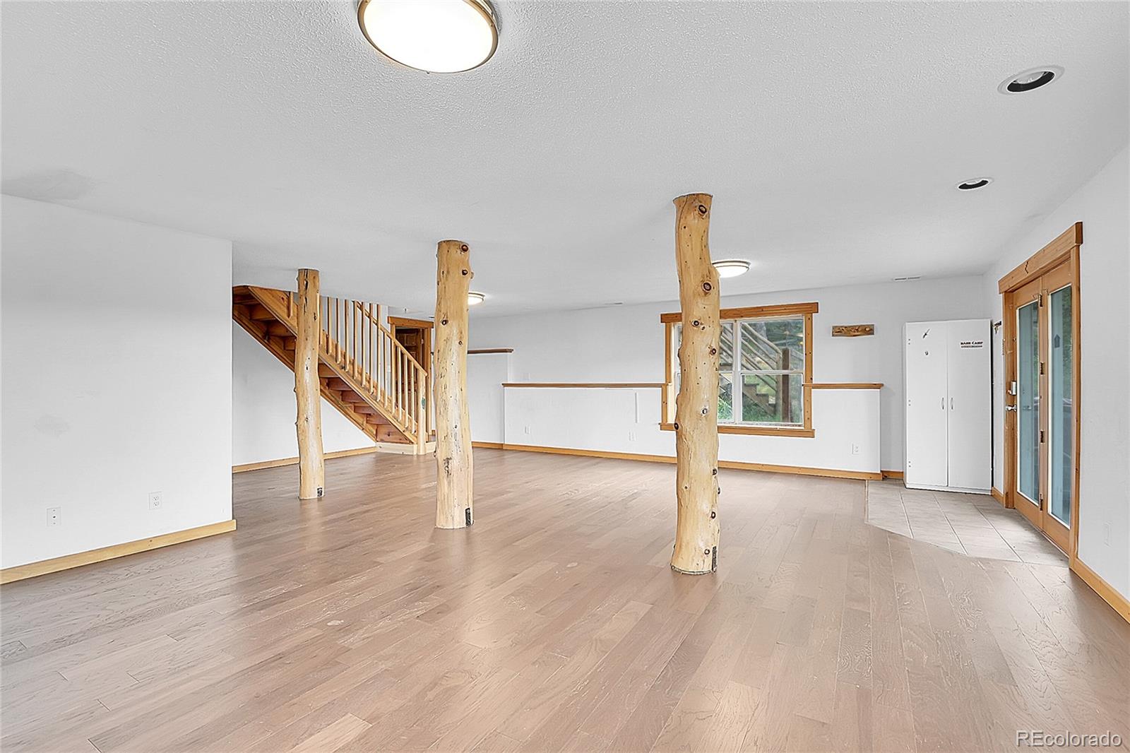 211 Chalet Drive Black Hawk, CO 80422 - Photo 20 of 36 a view of an empty room with stairs and a window
