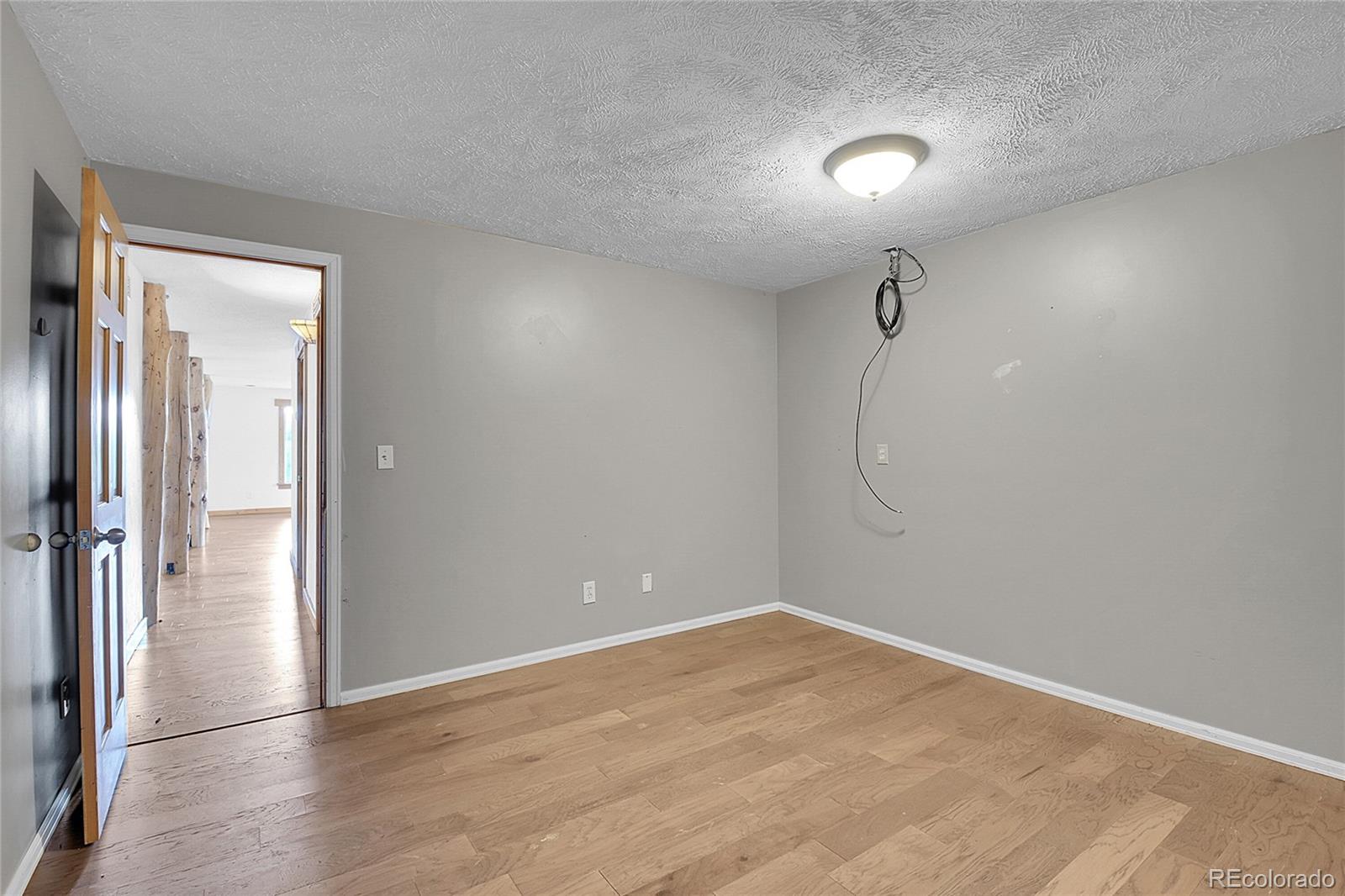 211 Chalet Drive Black Hawk, CO 80422 - Photo 24 of 36 wooden floor in an empty room