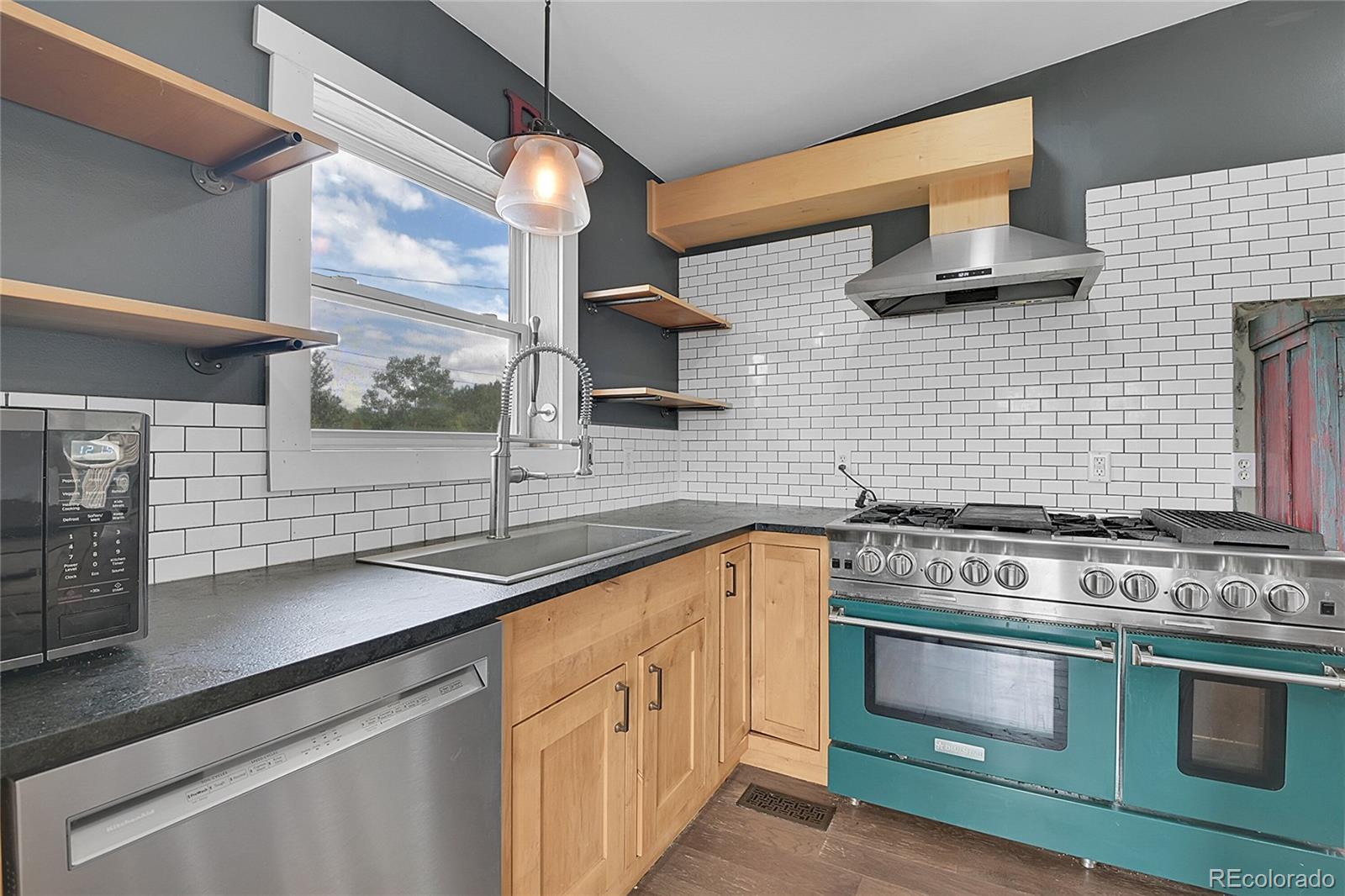 211 Chalet Drive Black Hawk, CO 80422 - Photo 3 of 36 a kitchen with stainless steel appliances a stove sink and cabinets