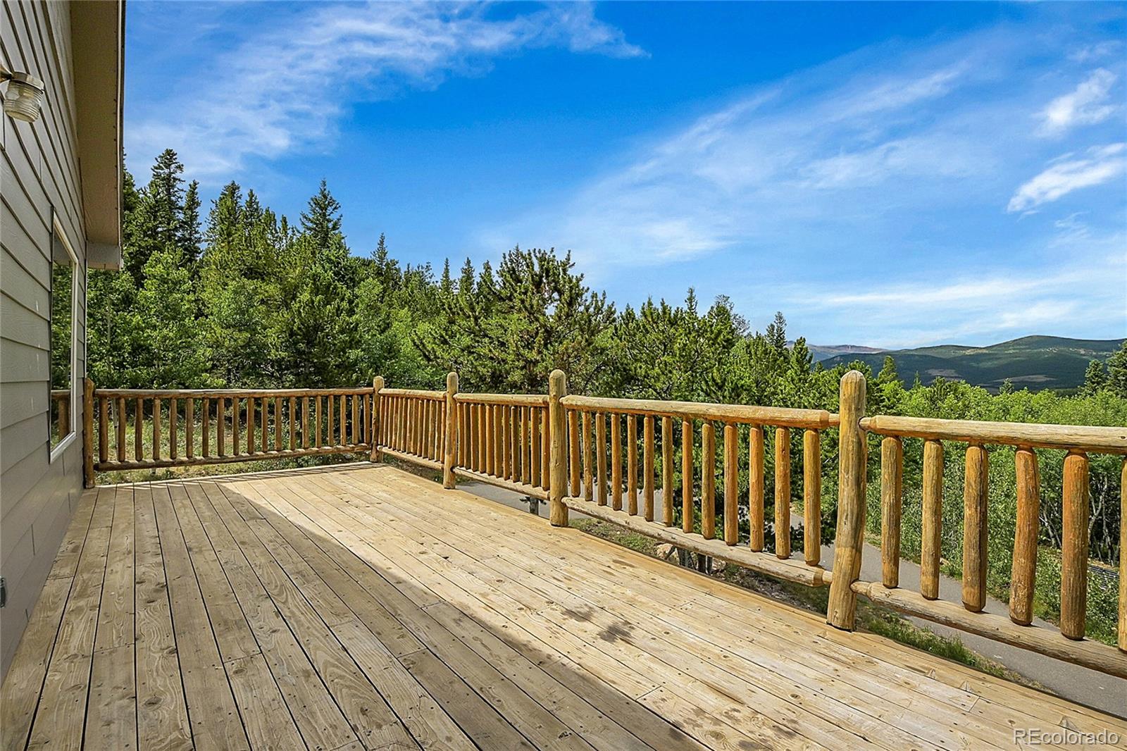 211 Chalet Drive Black Hawk, CO 80422 - Photo 31 of 36 a balcony with wooden floor and fence