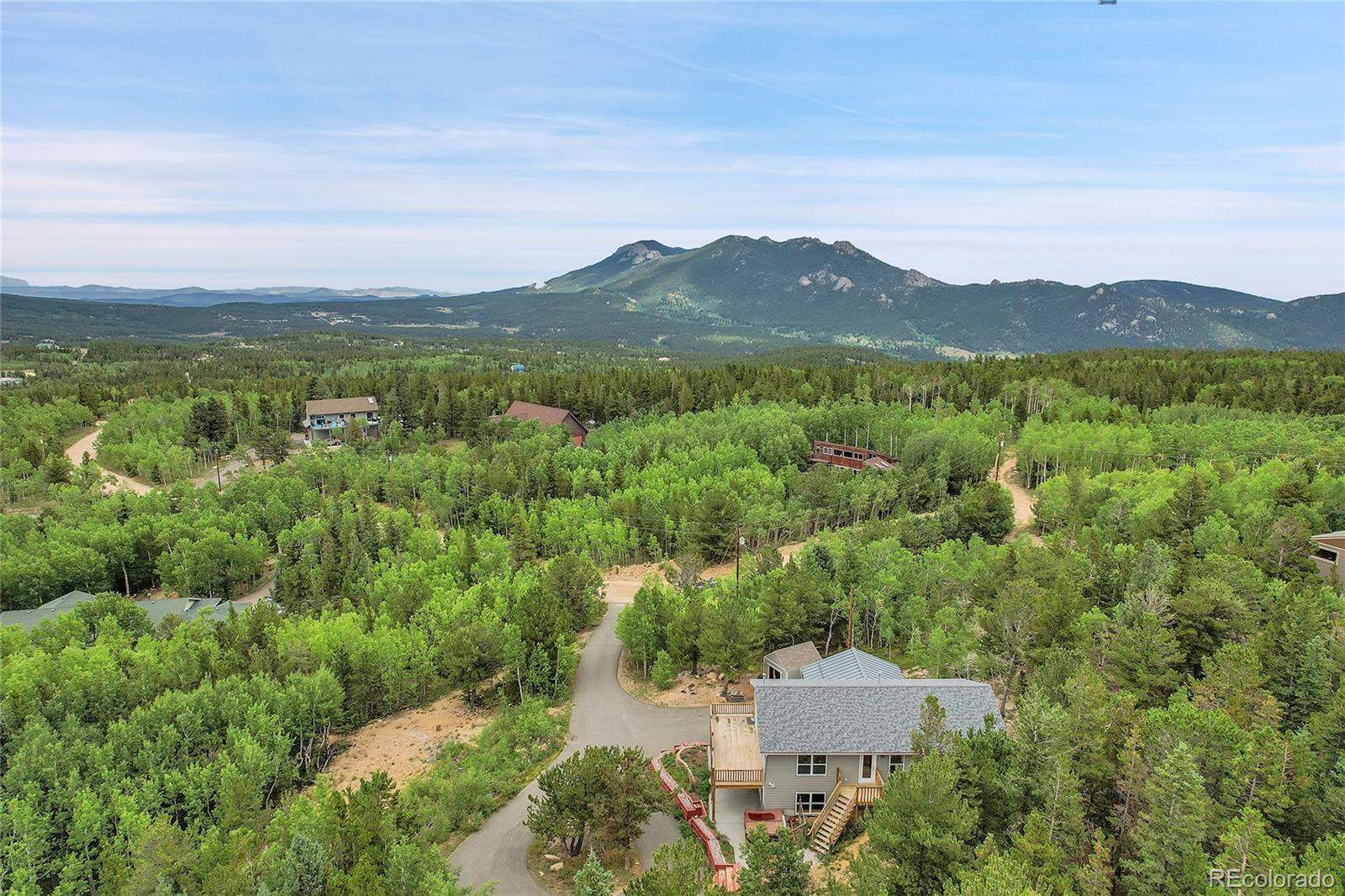 211 Chalet Drive Black Hawk, CO 80422 - Photo 33 of 36 an aerial view of houses covered in trees