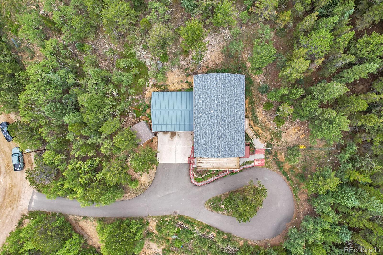 211 Chalet Drive Black Hawk, CO 80422 - Photo 35 of 36 an aerial view of a house with a yard and trees