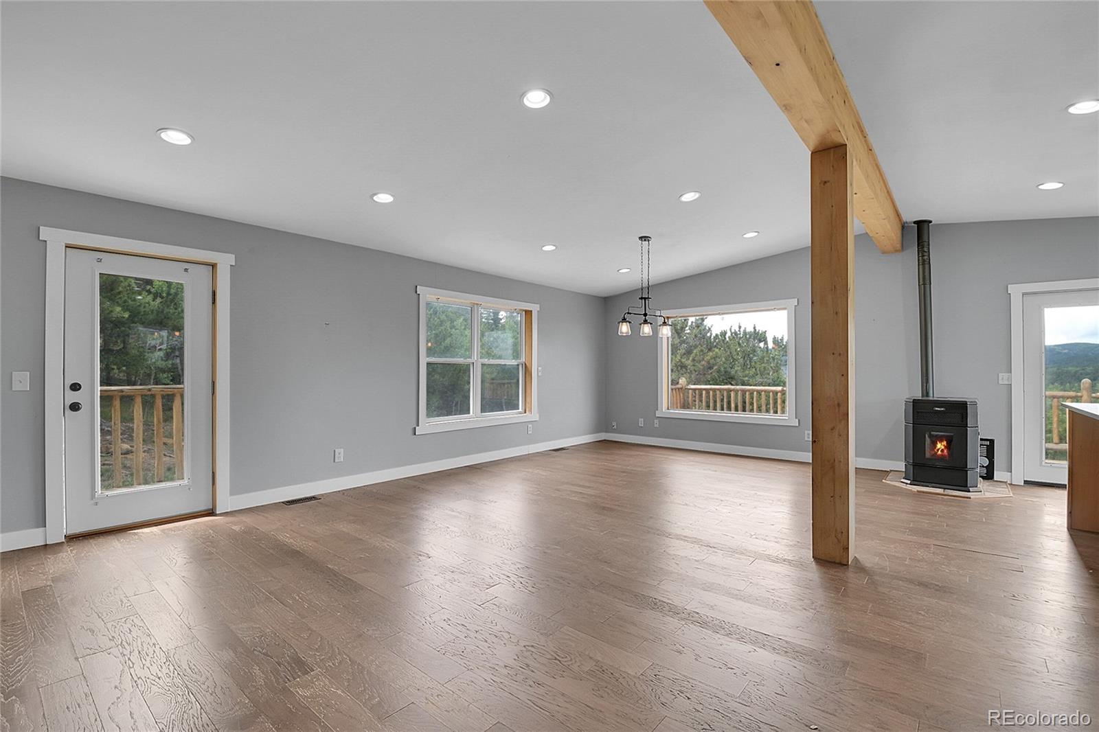 211 Chalet Drive Black Hawk, CO 80422 - Photo 6 of 36 a view of an empty room with wooden floor and a window