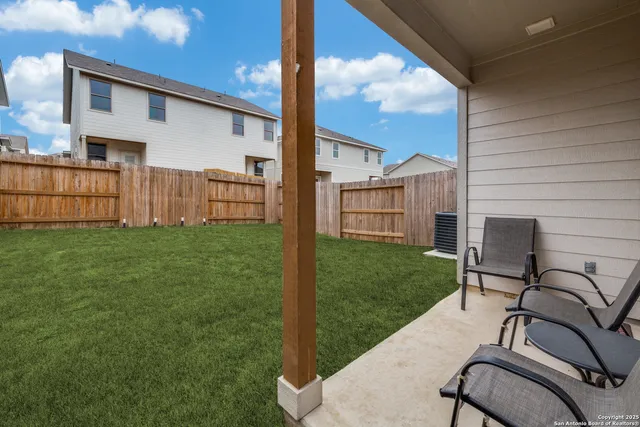 a view of backyard with barbeque grill and backyard