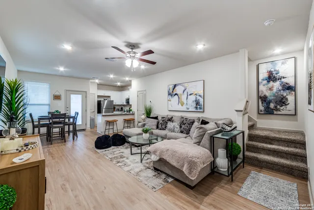 a living room with furniture and wooden floor