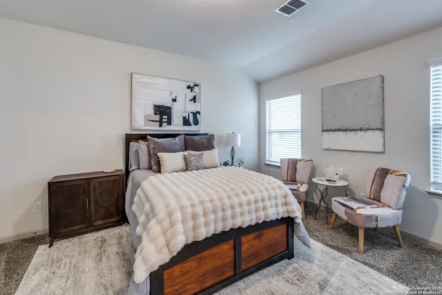 a bedroom with a bed and a couch