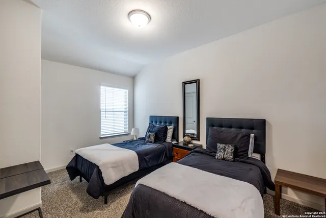 a bedroom with two beds and a window