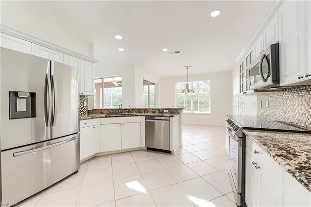 a kitchen with a stove top oven sink and cabinets
