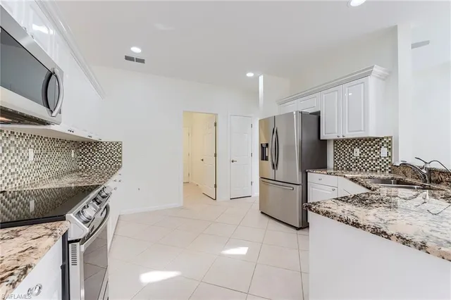a kitchen with a stove a refrigerator and a sink