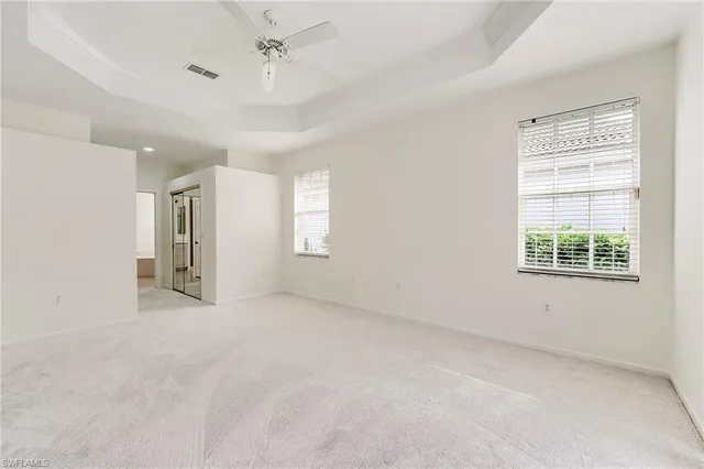 an empty room with windows and closet