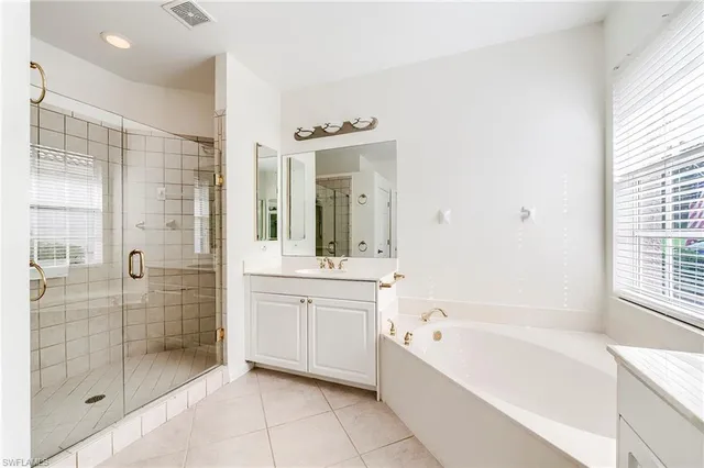 a large spacious bathroom with a granite countertop tub shower and sink