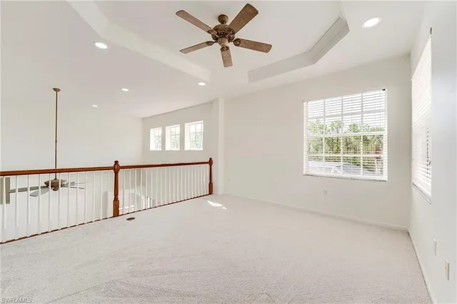 a view of a livingroom with a ceiling fan and window