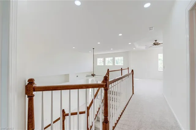 a view of a hallway with stairs