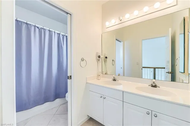 a bathroom with a double vanity sink and mirror