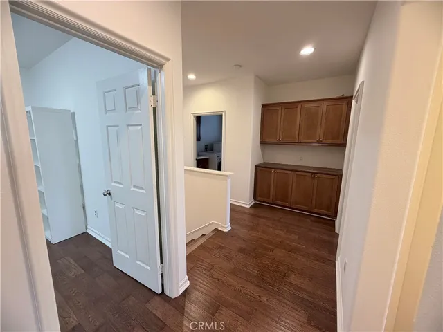 a view of a kitchen with wooden floor and electronic appliances