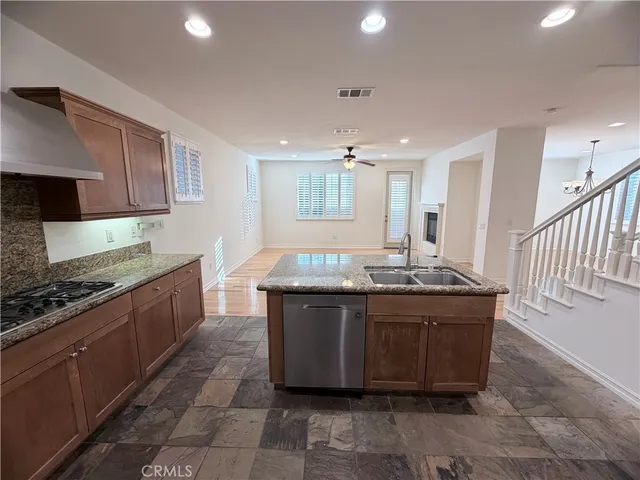 a large kitchen with kitchen island a sink stainless steel appliances and cabinets