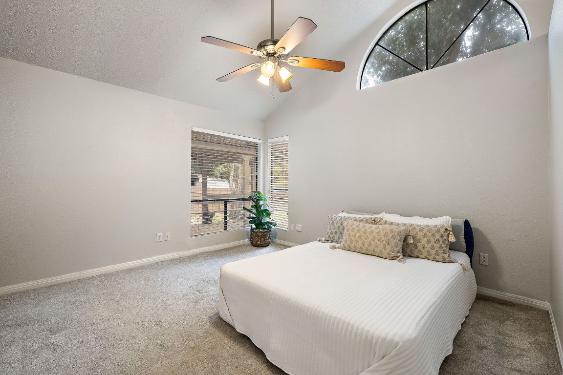 2013 Cervin Boulevard Austin, TX 78728 - Photo 11 of 31 a bedroom with a large bed and a chandelier