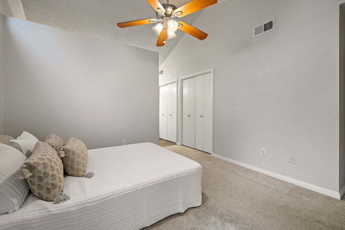 2013 Cervin Boulevard Austin, TX 78728 - Photo 12 of 31 a bedroom with a bed and a ceiling fan