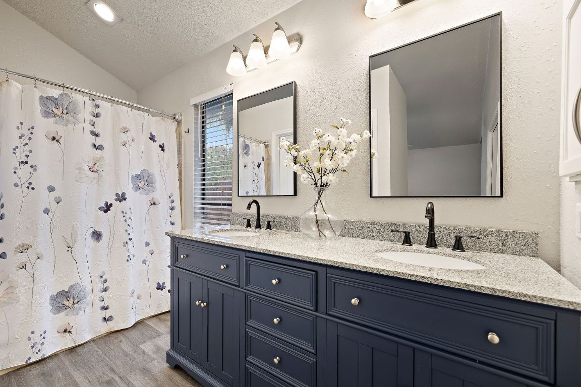 2013 Cervin Boulevard Austin, TX 78728 - Photo 13 of 31 a bathroom with double sink and a mirror