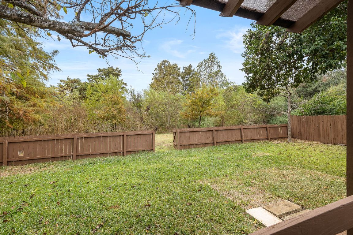 2013 Cervin Boulevard Austin, TX 78728 - Photo 21 of 31 a view of a backyard with a tree and wooden fence