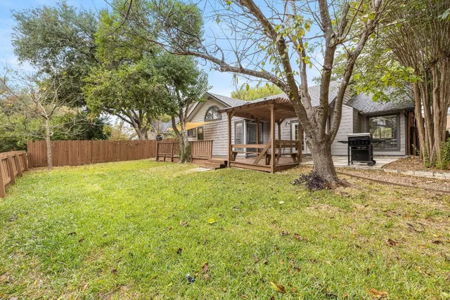 a view of a house with a tree in the yard