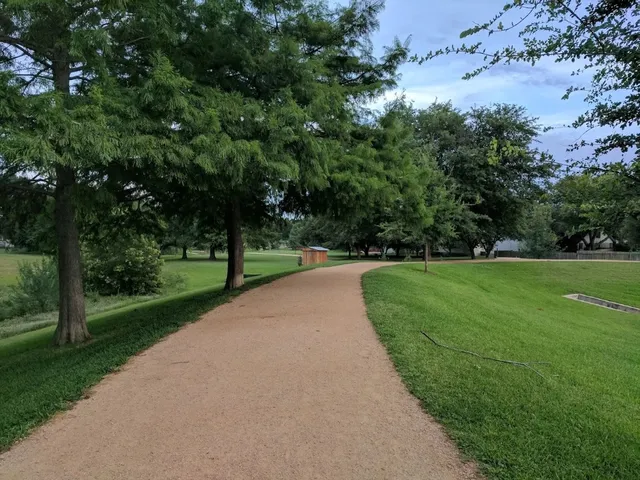 a view of green field with trees