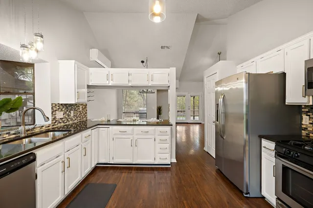 a kitchen with stainless steel appliances a refrigerator sink and stove