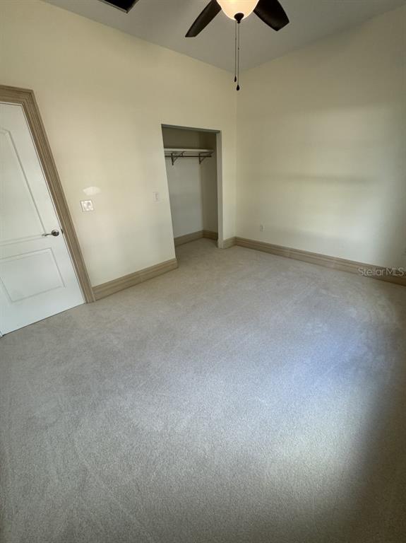 2383 Southwest 2nd Court Okeechobee, FL 34974 - Photo 24 of 48 en empty room with chandelier fan