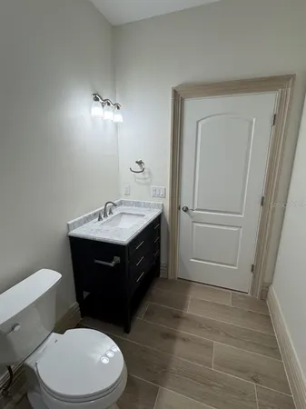 a bathroom with a sink a toilet a mirror and vanity