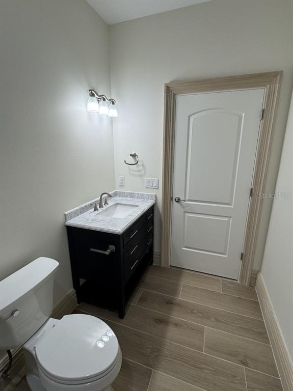 2383 Southwest 2nd Court Okeechobee, FL 34974 - Photo 27 of 48 a bathroom with a sink a toilet a mirror and vanity