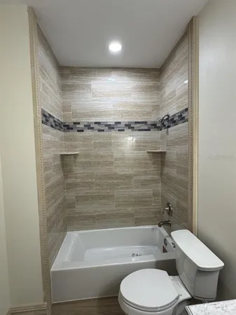 a bathroom with a toilet and a bathtub