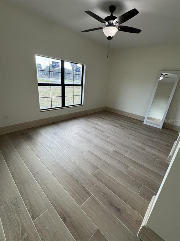 2383 Southwest 2nd Court Okeechobee, FL 34974 - Photo 29 of 48 an empty room with windows and ceiling fan