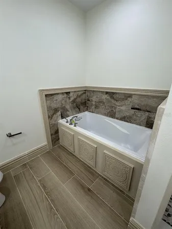 a bathroom with a bathtub and shower