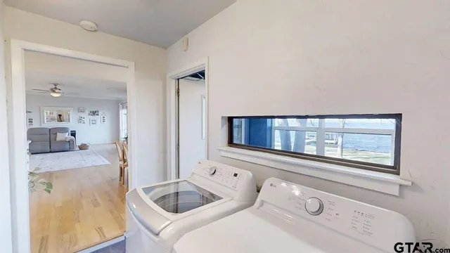 a bathroom with a granite countertop sink mirror and bathtub