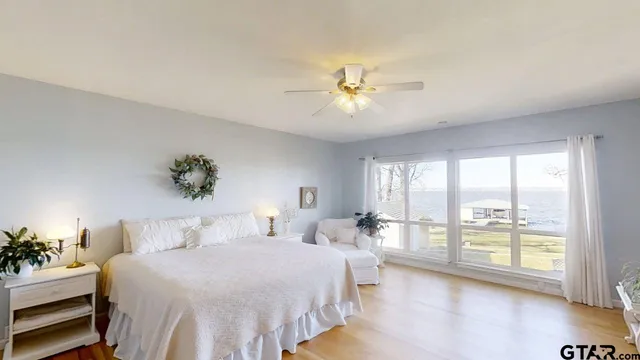 a bedroom with a large bed and a tv